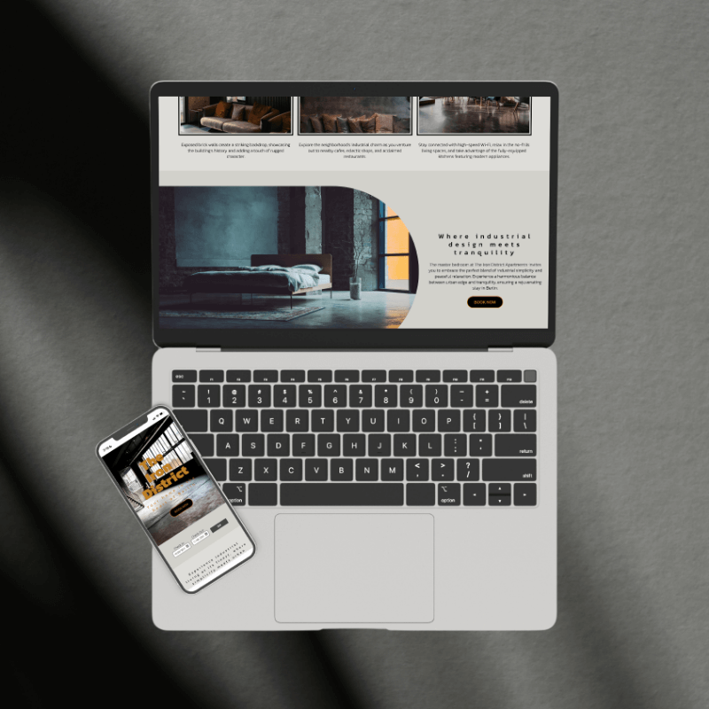 Laptop and mobile phone showcasing the website design for The Iron District.